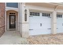 Close up of the main door and a 2-car garage of a nice townhouse at 305 Duval Dr, Alpharetta, GA 30009