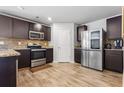 Well-lit kitchen featuring stainless steel appliances, stylish countertops, backsplash, and ample cabinetry at 400 Toronto Cir, Hampton, GA 30228