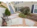 Serene patio space featuring two metal chairs, lush landscaping, and direct access to staircase at 500 Bainbridge Dr, Atlanta, GA 30327