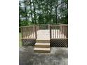 The new stained wooden deck is perfect for entertaining and grilling at 9866 Point View Dr, Jonesboro, GA 30238
