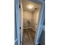 The laundry room boasts modern flooring and ample room for shelving and storage at 9866 Point View Dr, Jonesboro, GA 30238