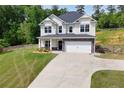 Attractive two-story home with well-maintained lawn, fenced property line, and a two-car garage at 47 Whitley Ct, Dallas, GA 30157