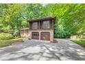 Charming two-story home with a two-car garage, beautiful brickwork, and a long driveway at 563 Navarre Dr, Stone Mountain, GA 30087