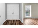 Inviting foyer with double doors, wood-look flooring, and a bright window, creating a warm entrance at 563 Navarre Dr, Stone Mountain, GA 30087