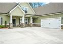 Stylish home with a wide driveway, stone accents, and an attached garage, creating great curb appeal at 100 Nemoura Ct, Fairburn, GA 30213
