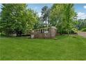 Expansive lawn surrounds this brick home, offering a serene setting with mature trees and landscaping at 2015 Twelve Oaks Nw Cir, Kennesaw, GA 30144