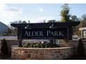 Elegant Alder Park community entrance sign amidst landscaping and brickwork at 2105 Boxwood Se Cir, Conyers, GA 30094