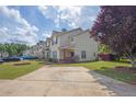 Pleasant townhome featuring a green lawn, a mature tree, and a designated parking space at 7293 Bridlewood Ct, Jonesboro, GA 30236
