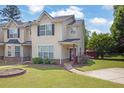 Attractive townhome showcasing a well-kept lawn, tidy landscaping, and a welcoming entrance at 7293 Bridlewood Ct, Jonesboro, GA 30236