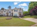 Charming townhome with a lush green lawn, a small garden, and a convenient parking area at 7293 Bridlewood Ct, Jonesboro, GA 30236