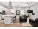Stylish living room and eat-in kitchen featuring a modern island, sleek finishes, and built in appliances at 991 Metropolitan Sw Pkwy, Atlanta, GA 30310