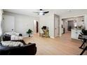 Inviting living room features hardwood floors, a modern ceiling fan, and easy access to kitchen at 4742 West Dr, Forest Park, GA 30297