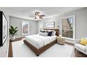 Serene bedroom with natural light, ceiling fan, and a comfortable queen-sized bed at 6851 Ne Roswell Rd # C4, Atlanta, GA 30328