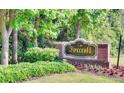 Entrance to Foxcroft Condominium with lush landscaping, flowers and clear signage at 6851 Ne Roswell Rd # C4, Atlanta, GA 30328