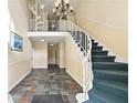 Condo entrance with staircase, wrought iron railing, and tiled floor at 6851 Ne Roswell Rd # C4, Atlanta, GA 30328