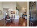 Elegant dining area with hardwood floors, chandelier, and seamless flow into the living space at 2703 Brookhavenrun Cir, Duluth, GA 30097