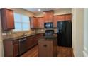 Modern kitchen with granite countertops, stainless steel appliances, a kitchen island, and abundant cabinet space at 3456 Sardis Bend Dr, Buford, GA 30519