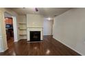 Inviting living room features a fireplace, hardwood floors, and seamless flow into the adjacent kitchen at 3456 Sardis Bend Dr, Buford, GA 30519