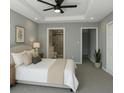 Cozy bedroom with a tray ceiling, neutral color palette, and a view into the ensuite bathroom at 4011 Redan Rd # 10, Stone Mountain, GA 30083