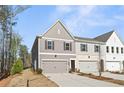Two-story home with gray siding, a two-car garage, and manicured lawn at 401 Carrera Ln, Acworth, GA 30102