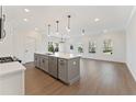 Bright kitchen with modern gray cabinets, island, stainless appliances, and hardwood floors at 401 Carrera Ln, Acworth, GA 30102