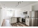 Bright, modern kitchen features stainless steel appliances, white cabinets, and durable countertops at 525 Parkway Dr # 218, Atlanta, GA 30354