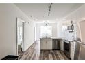 Modern kitchen with stainless steel appliances, white cabinetry, and a stylish chandelier over the central island at 525 Parkway Dr # 218, Atlanta, GA 30354