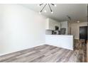 Eat-in kitchen featuring stainless steel appliances, white cabinets, and wood-look flooring at 525 Parkway Dr # 218, Atlanta, GA 30354