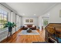 Inviting living room features hardwood floors, a leather sofa, and a bay window offering lots of natural light at 5661 Fairwood Nw Dr, Acworth, GA 30101