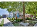 Quaint light blue house with charming front porch, complemented by lush landscaping and a shaded yard at 230 Ryan Ln, Covington, GA 30014
