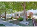 A quaint, light blue house with a welcoming front porch is shaded by a large tree and lush landscaping at 230 Ryan Ln, Covington, GA 30014