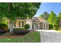Inviting home featuring stone and siding facade, lush landscaping, and a basketball hoop, complemented by a well-maintained lawn at 931 Windsor Creek Dr, Grayson, GA 30017