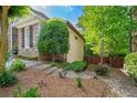 Home exterior showcasing a blend of stone and siding, accented by lush greenery and a charming stone pathway at 931 Windsor Creek Dr, Grayson, GA 30017