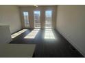 Sunlit living room featuring hardwood floors and ample natural light at 1274 Longreen Terrace Nw # 114, Atlanta, GA 30318