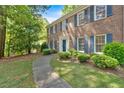 Beautiful two-story brick home with blue shutters and meticulously landscaped yard, showcasing curb appeal at 4181 Singing Post Ne Ln, Roswell, GA 30075