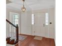 Bright foyer with hardwood floors, white wainscoting, and views of the staircase and front door at 4181 Singing Post Ne Ln, Roswell, GA 30075