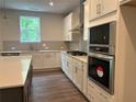 Well-equipped kitchen boasts stainless appliances, ample cabinetry, and stone countertops at 93 Riverwood Dr, Dallas, GA 30157