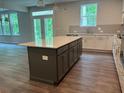 Stylish kitchen showcases a center island, two-tone cabinets, and modern fixtures at 93 Riverwood Dr, Dallas, GA 30157
