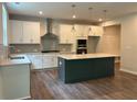 Bright, open kitchen featuring a large island, stainless steel appliances, and modern pendant lighting at 93 Riverwood Dr, Dallas, GA 30157
