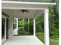 This home's covered patio features a ceiling fan and provides a private space to relax and entertain at 93 Riverwood Dr, Dallas, GA 30157