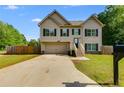 Inviting two-story home with a front yard and attached garage, perfect for comfortable living at 119 Sourwood Lane, Temple, GA 30179