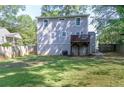 Spacious backyard features a small deck, a well-maintained lawn, and a privacy fence, perfect for outdoor activities at 1390 Almont Sw Dr, Atlanta, GA 30310