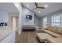 Bright living room featuring hardwood floors, a high ceiling with ceiling fan, and ample natural light, creating a cozy atmosphere at 1390 Almont Sw Dr, Atlanta, GA 30310