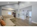 Open-concept living space featuring hardwood floors, grey walls, and a seamless transition to the adjacent dining and kitchen areas at 1390 Almont Sw Dr, Atlanta, GA 30310