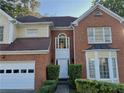 Beautiful two-story brick and siding home featuring an attached garage and landscaped front yard at 350 Rams Way, Tucker, GA 30084