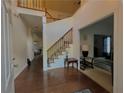Bright foyer with hardwood floors, a staircase, and views into adjoining living spaces at 350 Rams Way, Tucker, GA 30084