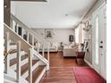 Bright living room with hardwood floors, white trim, large window, and comfortable seating at 5022 Audubon Pl, Norcross, GA 30093