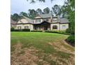 Charming two-story home with a stone and siding exterior, a well-manicured lawn and mature landscaping at 6213 Arnall Nw Ct, Acworth, GA 30101