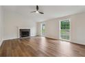 Bright living room with a cozy fireplace, ample natural light, and sleek hardwood floors at 3343 Mooring Dr, Powder Springs, GA 30127