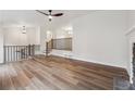 Spacious living room featuring hardwood floors, a fireplace, and an open design leading to other living spaces at 3343 Mooring Dr, Powder Springs, GA 30127